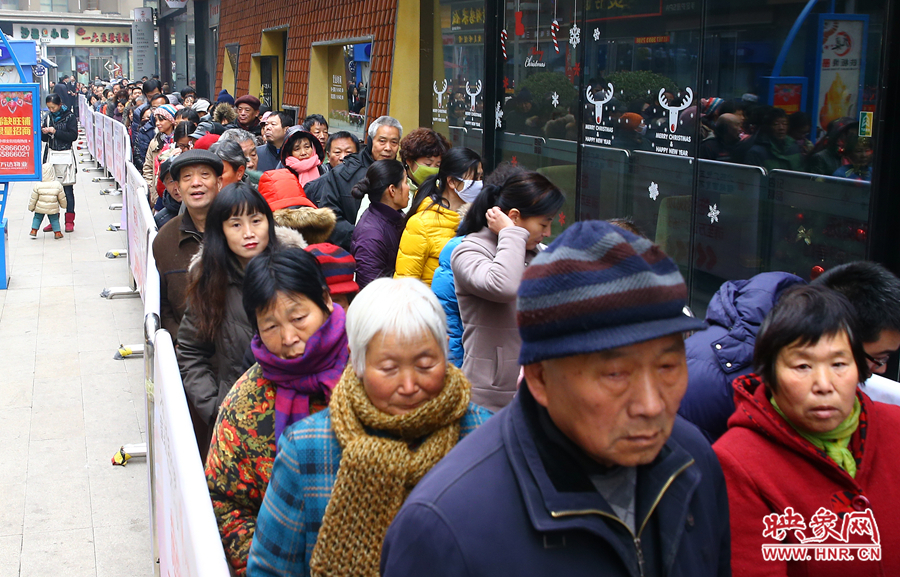 領(lǐng)粥的市民排起了長隊(duì)，足有上千人。