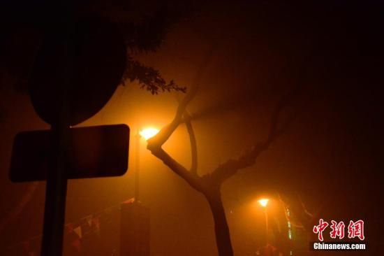 1月31日凌晨，市民行走在煙霧繚繞的南京街頭。當(dāng)天是農(nóng)歷馬年正月初一，南京有限開禁燃放煙花爆竹正逢下霧天，空氣的不流通致使煙花爆竹燃燒后產(chǎn)生的顆粒物不能及時散開，造成整座城市煙霧繚繞。據(jù)當(dāng)?shù)丨h(huán)保部門發(fā)布的信息顯示，空氣質(zhì)量屬重度污染。中新社發(fā) 泱波 攝