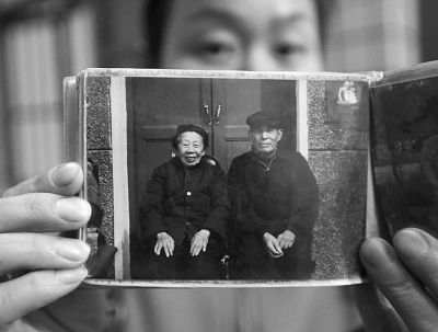 圖為孫女拿出兩位老人上世紀80年代在家門口的合影給記者看。記者楊濤 攝